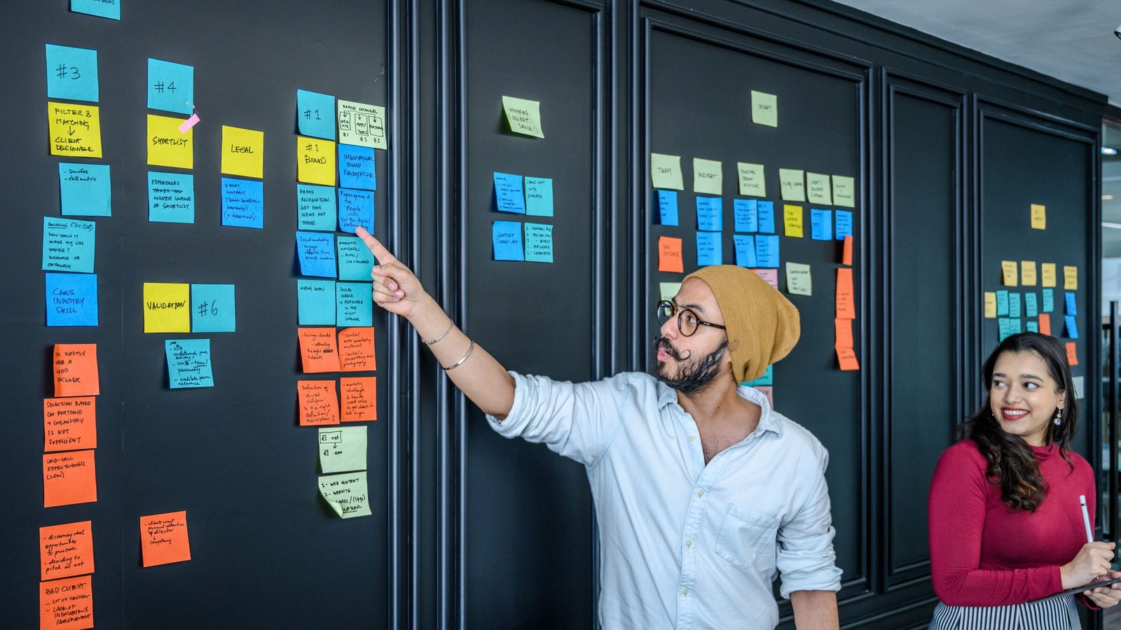 Team discussing project strategies with colorful sticky notes on board