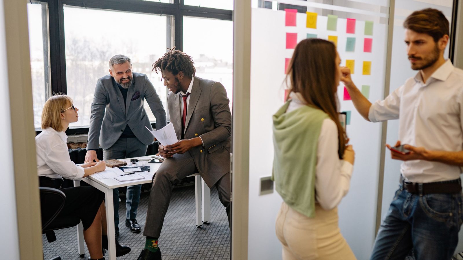 Office environment with diverse team members brainstorming and collaborating on a project