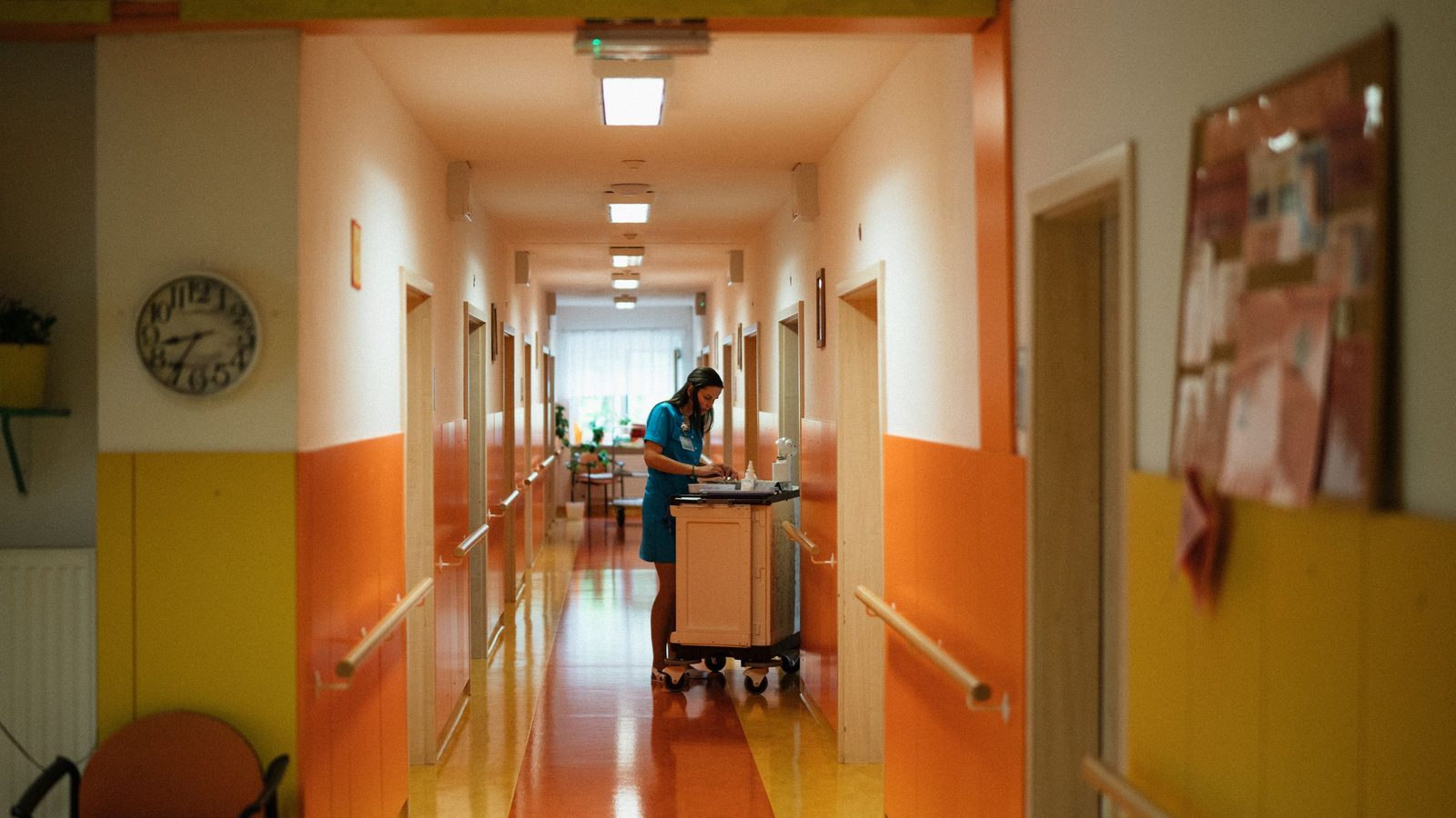 A nurse attending to duties in a hospital corridor